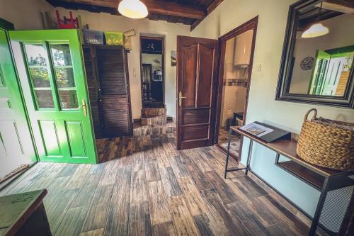 a room with green doors and a wooden floor at Padláskincsek Vendégház in Nagybörzsöny