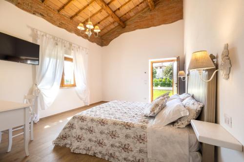 a bedroom with a bed and a table and a window at B&B Podere Curtatone in Grosseto