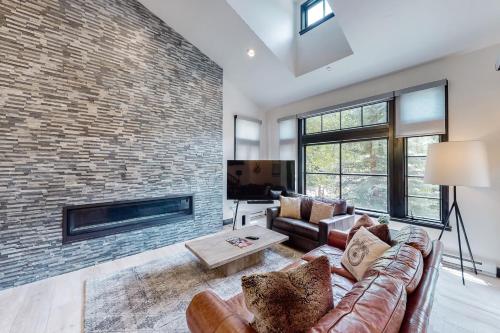 a living room with a couch and a brick wall at Beaver Creeks Meadows in Beaver Creek