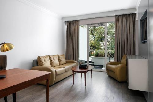 a living room with a couch and a table at Four Points by Sheraton Arusha, The Arusha Hotel in Arusha