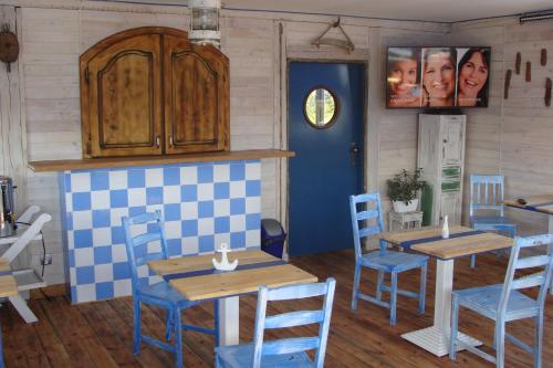 a dining room with two tables and blue chairs at K 2 in Jastrzębia Góra