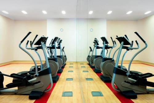 a gym with a row of cardio machines at Sheraton Sharjah Beach Resort and Spa in Sharjah