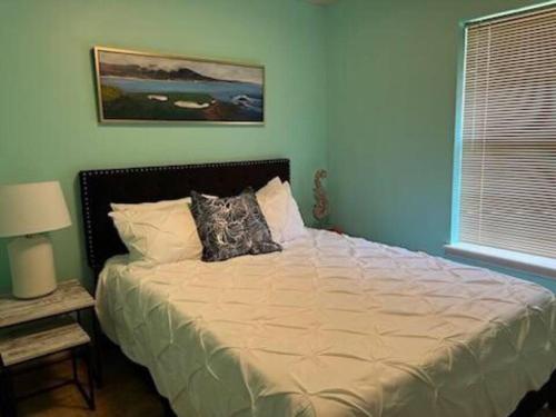 a large bed in a bedroom with a window at A Bliss of Color Townhouse in Jackson