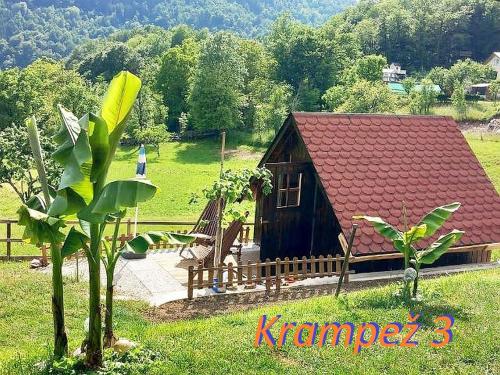 a small house with a bench and a tree at Krampez in Kobarid