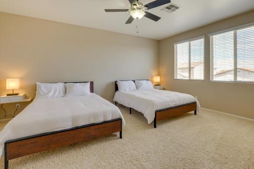 a bedroom with two beds and a ceiling fan at Pool, Fire Pit Family Home in Goodyear! in Goodyear