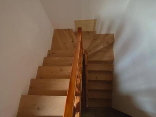 un conjunto de escaleras en una habitación con paredes blancas en Guesthouse Rexhepi, en Kolgecaj
