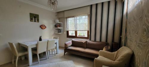 a living room with a couch and a table and chairs at An Easy Transport and Quiet Apartment in Istanbul in Istanbul