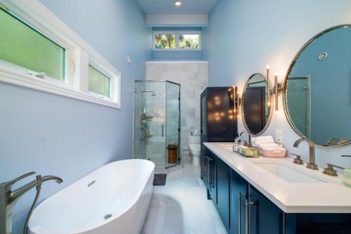 a bathroom with two sinks and a tub and a shower at 2932 Captain Sams in Johns Island