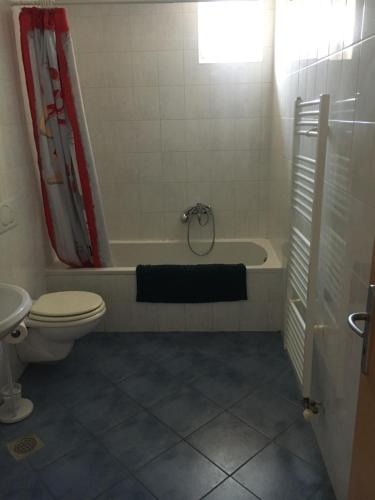 a bathroom with a tub and a toilet and a sink at Apartma Lunca 2 in Ljubljana