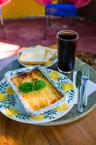 a table with a plate of food and a cup of coffee at Cabañas Los Venaos in San Bernardo del Viento