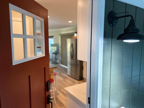 a door to a kitchen with a light on the wall at Crescent Bar Waterfront Home- Private Beach, Water Views, Hiking, Golf, Live Concerts in Quincy