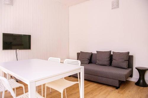 a living room with a white table and a couch at Latitude - Appartement proche Notre Dame de la Garde in Marseille