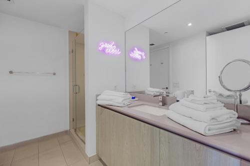 a bathroom with a sink and a mirror and towels at Seashore Resort #3805 - 2 BEDROOM RIGHT ON THE BEACH DIRECT OCEAN-VIEW WITH AMENITIES ON THE ROOFTOP in Hollywood