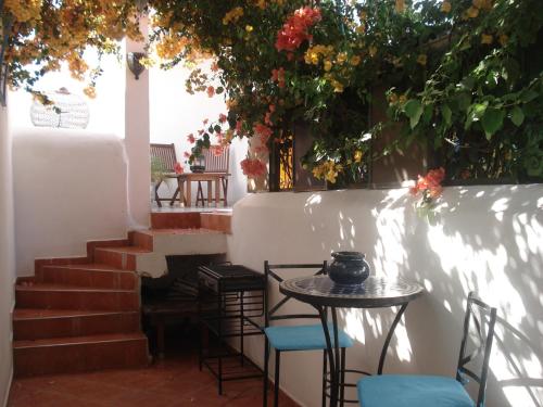 a patio with a table and chairs and stairs at Riad Marlinea in Sale