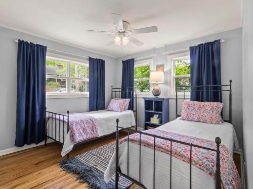 a bedroom with two beds and a ceiling fan at Honeysuckle Hideaway in Fayetteville