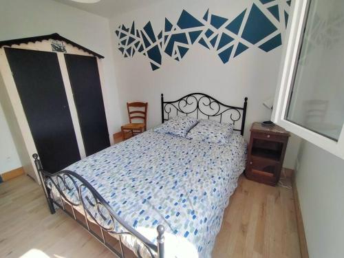 une chambre avec un lit avec une couette bleue dans l'établissement Maison à 15 minutes de la Baie de Somme, à Friville-Escarbotin