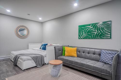 a living room with a couch and a bed at Le Sous-Bois 1322 Billard et Spa in Mont-Blanc