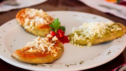 a white plate with three pieces of food on it at Hotel Mixti in Cuetzalán del Progreso