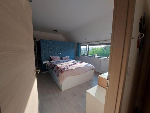a small bedroom with a bed and a window at La Clé du Circuit Spa-Francorchamps in Stavelot