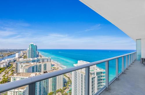 a balcony with a view of the ocean and buildings at The Ultimate Resort - BEACHFRONT 2 BEDROOM APARTMENT WITH DIRECT OCEAN VIEW, ROOFTOP POOL, HOT TUB AND GYM in Hollywood