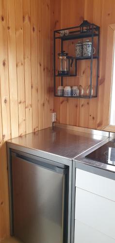 a kitchen with a stove and a counter top at Tiny and cosy house in the countryside in Hella