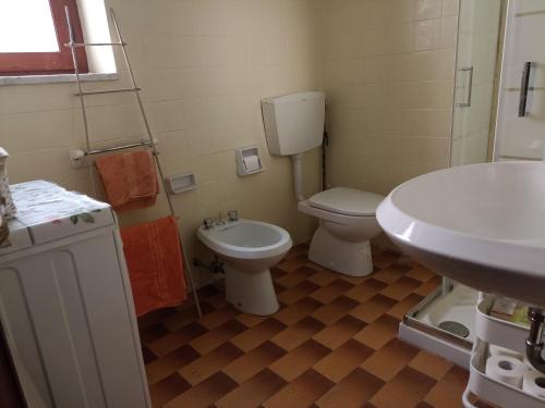 a bathroom with a toilet and a sink at Old Town House in San Romano