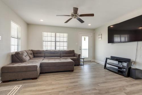 a living room with a couch and a ceiling fan at Waterfront Alabama Vacation Rental with Deck in Coden