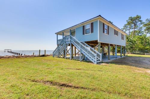 a house on the beach with a large yard at Waterfront Alabama Vacation Rental with Deck in Coden