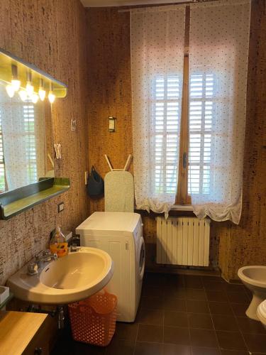 a bathroom with a sink and a small refrigerator at Appartamento VILLAMARE in Numana