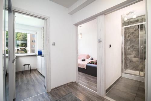 a room with a glass door leading to a bedroom at Leśny zakątek in Gdańsk
