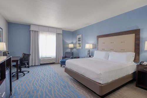 a large hotel room with a bed and a desk at Holiday Inn Express and Suites Edwardsville, an IHG Hotel in Edwardsville