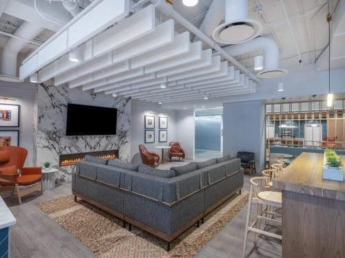 a lobby with a couch and a fireplace at Holiday Inn Chicago O'Hare - Rosemont by IHG in Rosemont