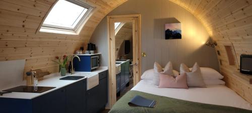 a bedroom with a bed in a room with a window at Odli Glamping - Deri in Welshpool