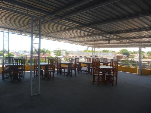 a group of tables and chairs in a building at APARTHOTEL CENTRAL MACAPÁ in Macapá