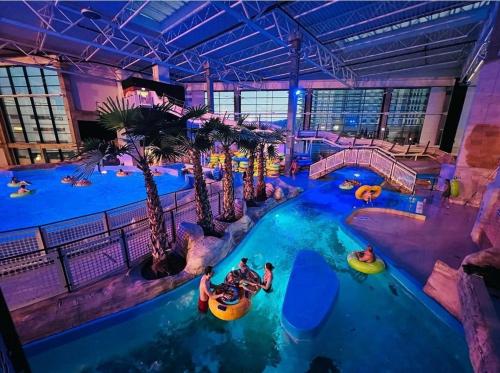 an indoor water park with people in a pool at Apartament Rodzinny Przy AquaParku in Reda
