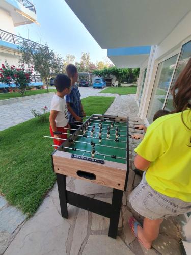 a group of people playing a game of chess at Philoxenia Apartments in Kryonéri