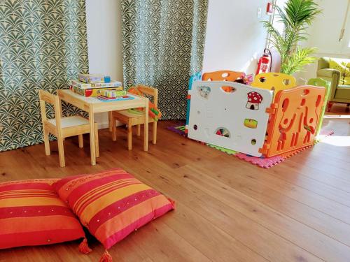 a childs room with a table and a table and chairs at Garden Hotel Primavera in Brissago
