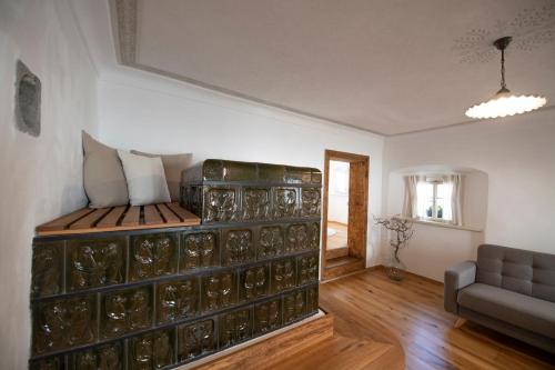 a room with a bed and a couch at MEŽNARIJA Radovljica in Radovljica