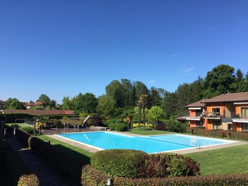 a swimming pool in a yard next to a house at This is my happy place in Leggiuno