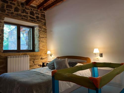a bedroom with a bed and a window at SANABRIA - Palacio de La Cuesta in Palacios de Sanabria