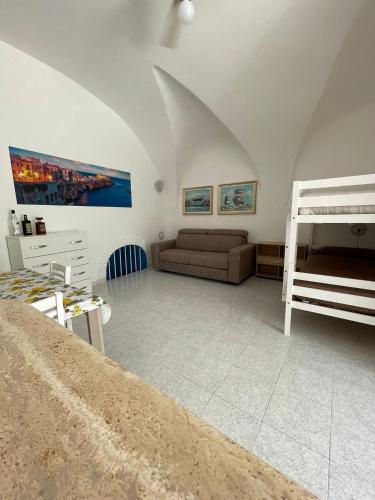 a living room with a couch and a bunk bed at Dimora Marina sul Gargano in Vieste