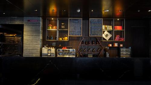 a bar in a restaurant with a counter top at Crowne Plaza Kochi by IHG in Cochin