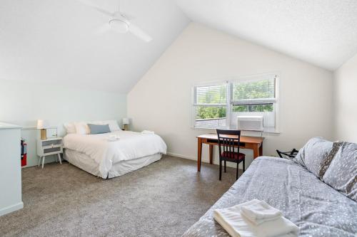 a bedroom with a bed and a desk with a table at Heron Hideaway in Wilkesboro