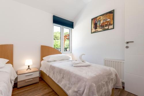 a bedroom with two beds and a window at Apartment Ivana in Šibenik