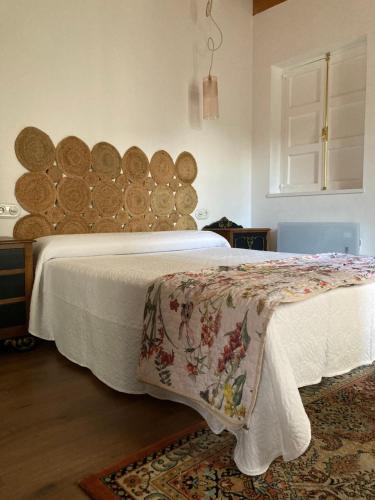 a bedroom with a bed with a large wooden headboard at Casa Utopia 1 in Grado