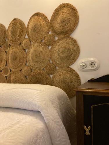 a bedroom with a wall covered in large wooden spheres at Casa Utopia 1 in Grado