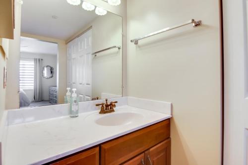 a bathroom with a sink and a mirror at Beachfront Ocean City Condo with Pool and Views! in Ocean City