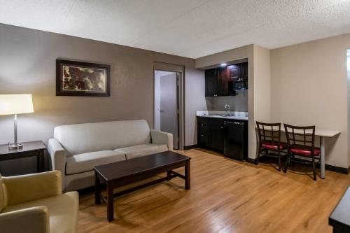 a living room with a couch and a table at Red Roof Inn PLUS+ & Suites Knoxville West - Cedar Bluff in Knoxville