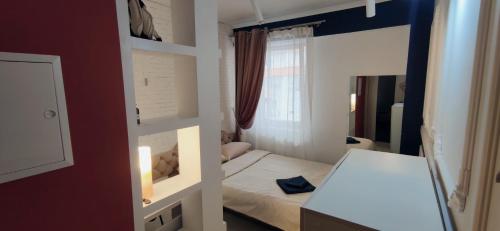 a small room with a bed and a mirror at Inessa Center Guest PenthHouse in Chişinău