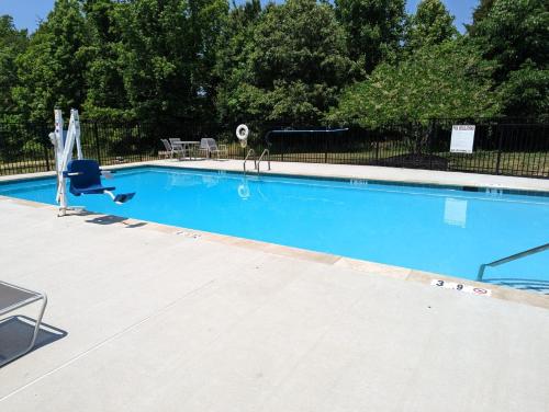 a swimming pool with a chair and a volley ball at Candlewood Suites Aberdeen-Bel Air by IHG in Riverside